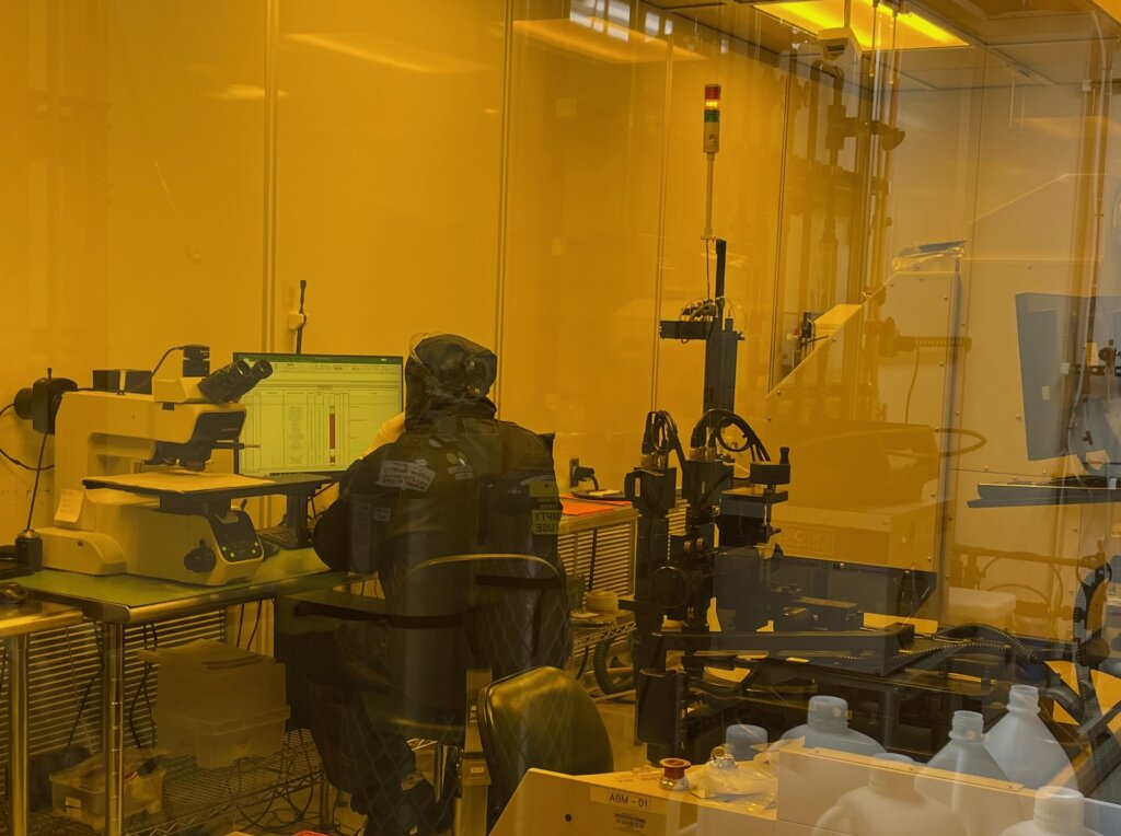 Technician in the lithography cleanroom reviews measurements. 